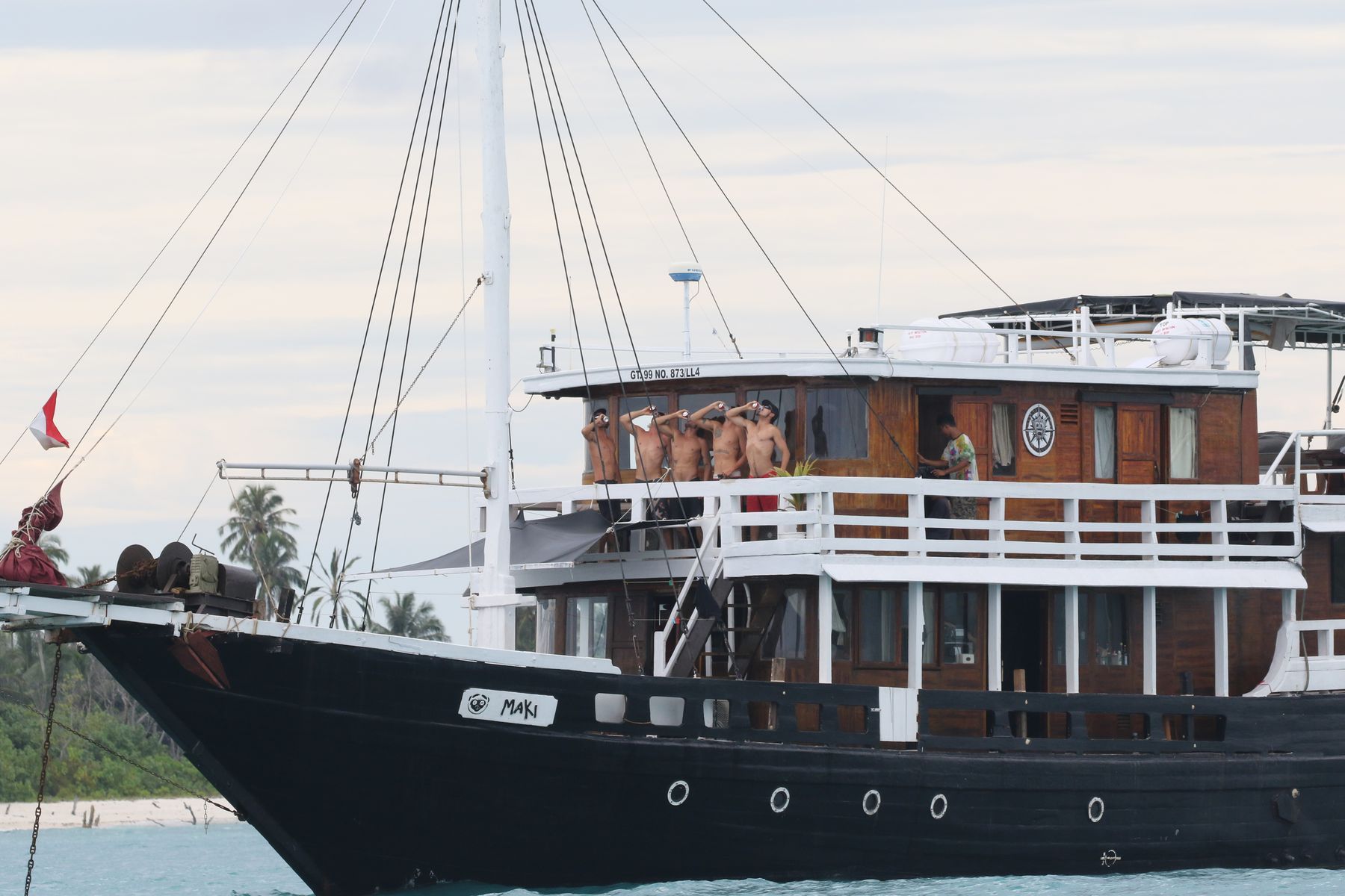 Crew and guests toasting aboard Maki