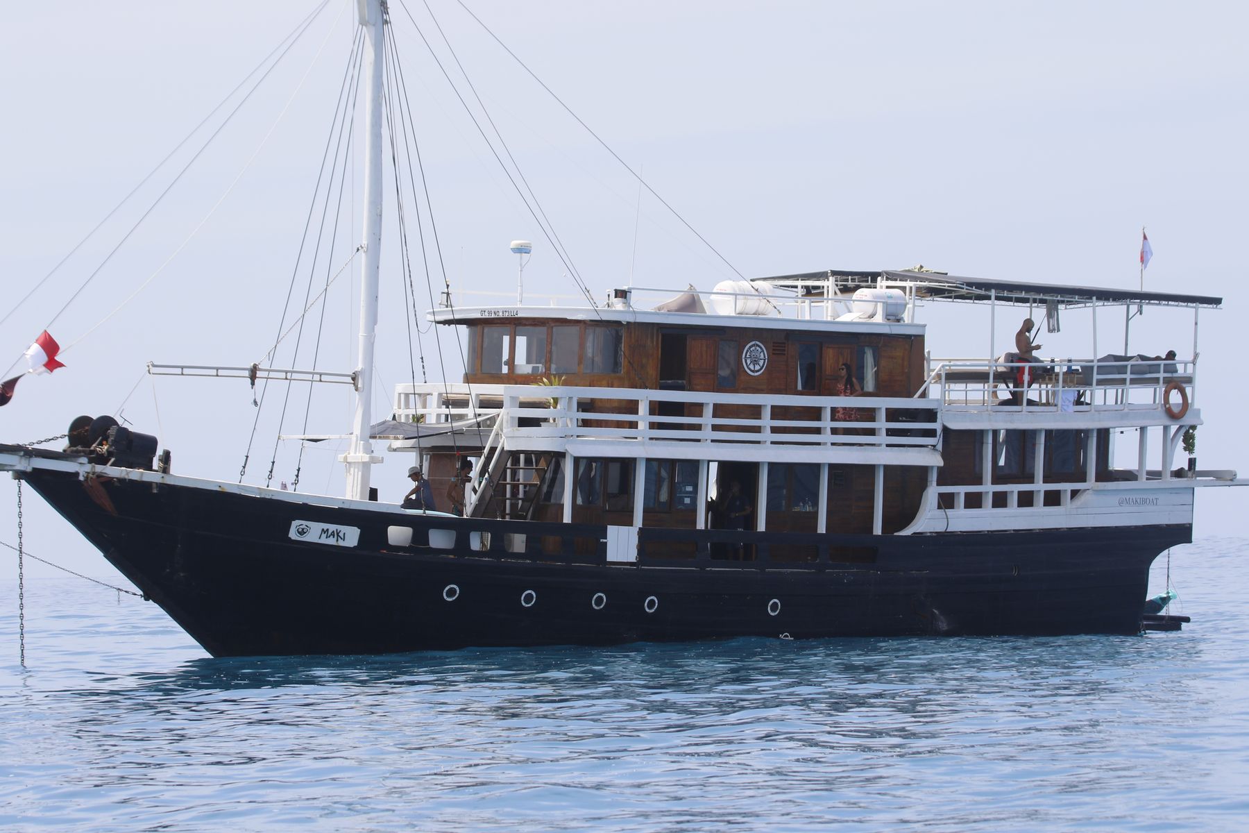 Maki at anchor, wide view with guests on deck