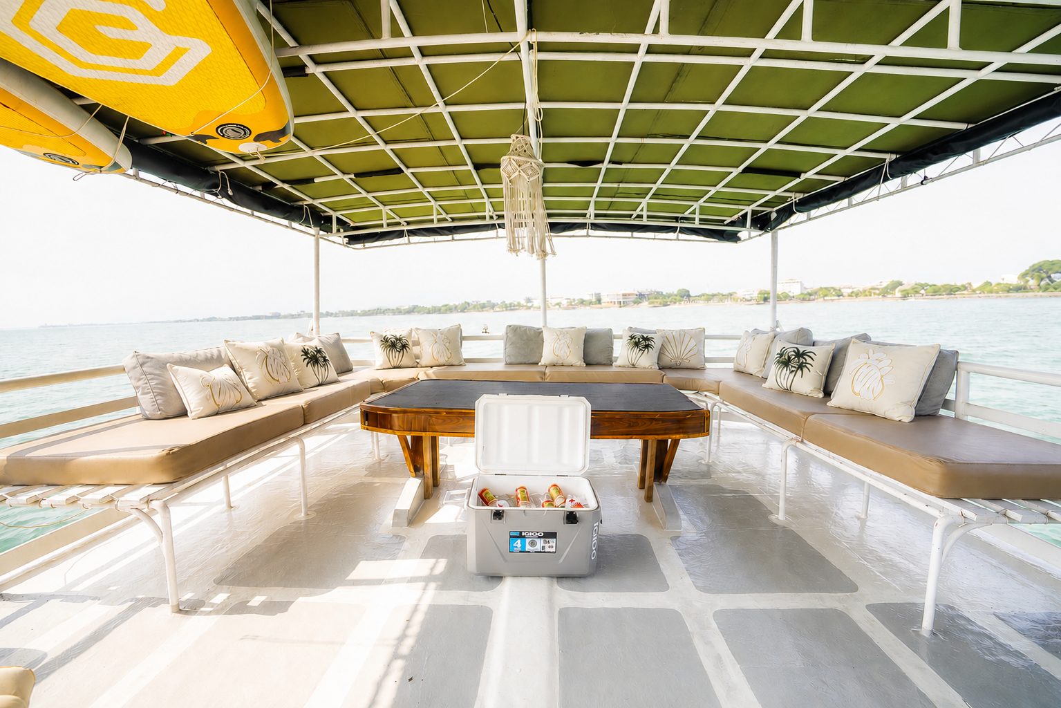 Deck lounge and dining table aboard Maki