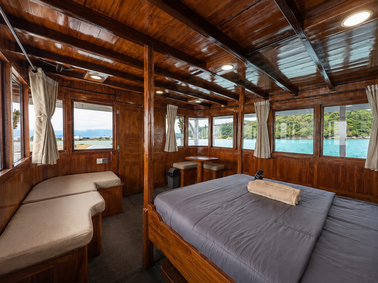 Private wood-paneled cabin aboard Maki with sea view